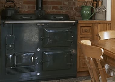 a black classic two oven Aga in a old fashioned kitchen